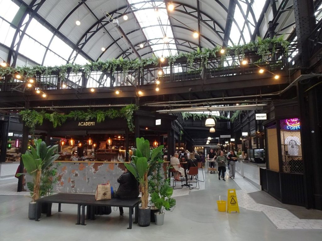 stalls inside a busy indoor market hall